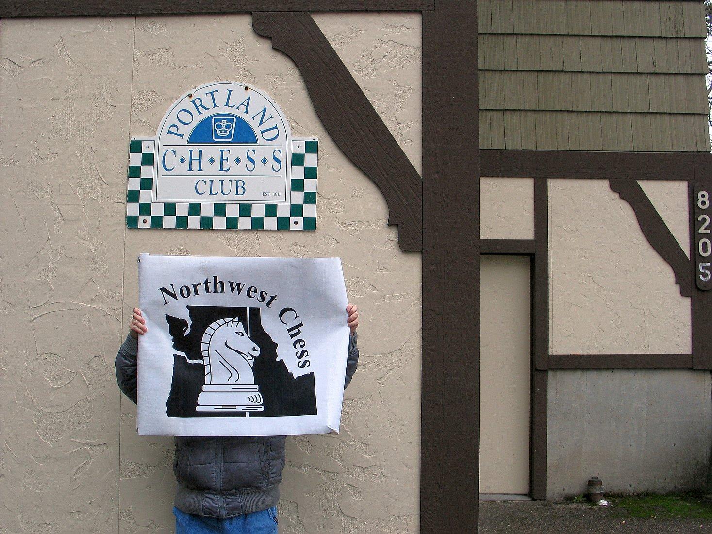 Photo Credit: Russell Miller. Kathy Miller holding NWC banner outside Portland CC.