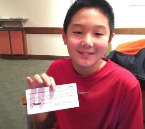 Jack Woo McClain shows prize check from Oregon Class.